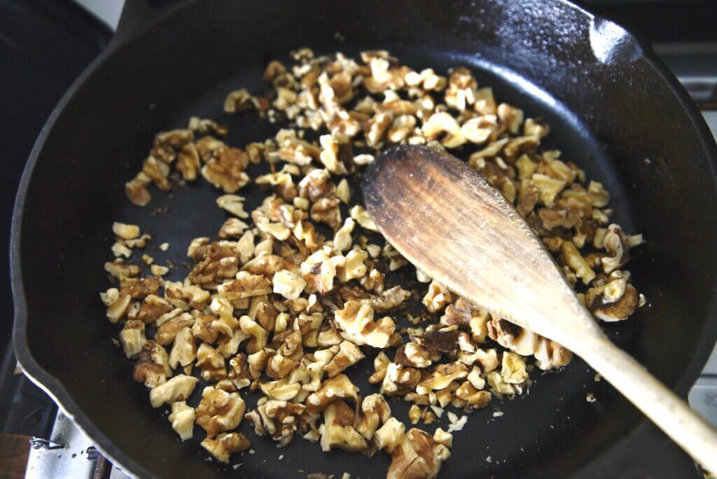 roasted walnuts in cast iron skillet