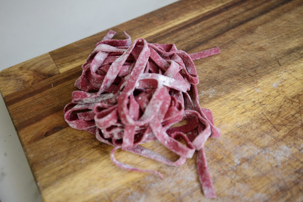 Single serving of homemade noodles on a wooden cutting board.