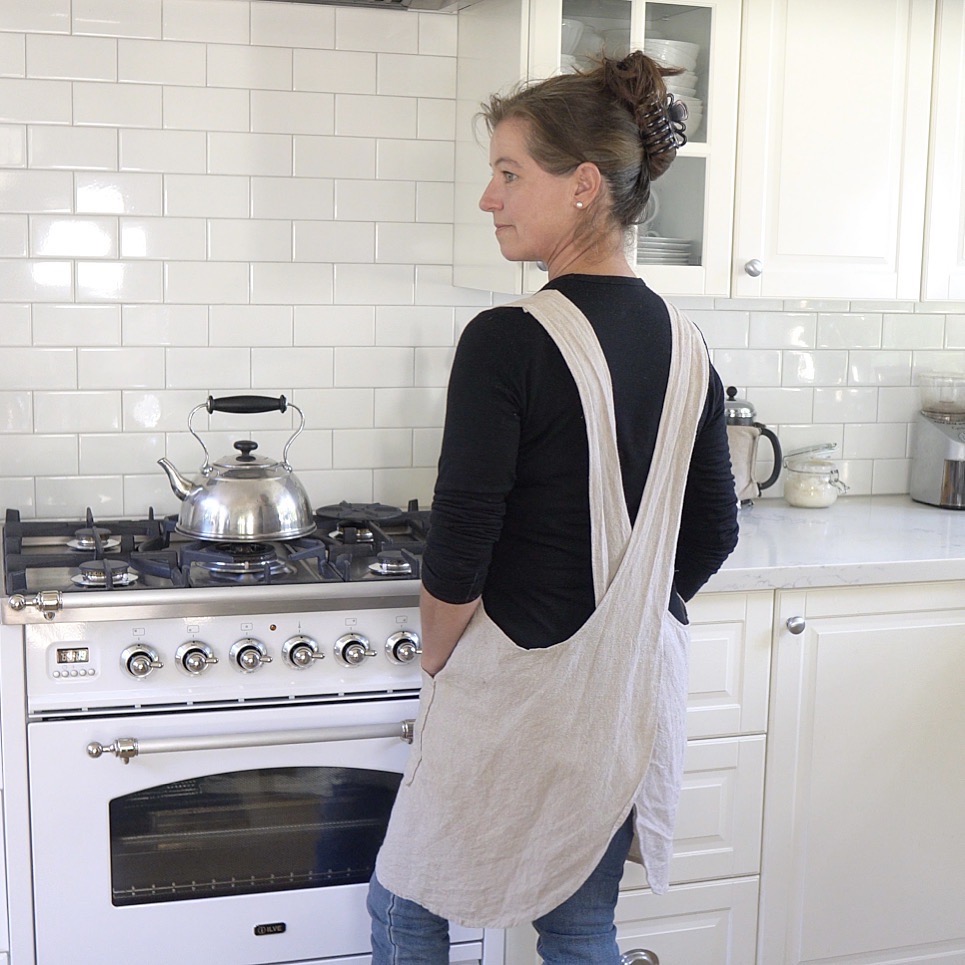 woman wearing cross back apron in kitchen