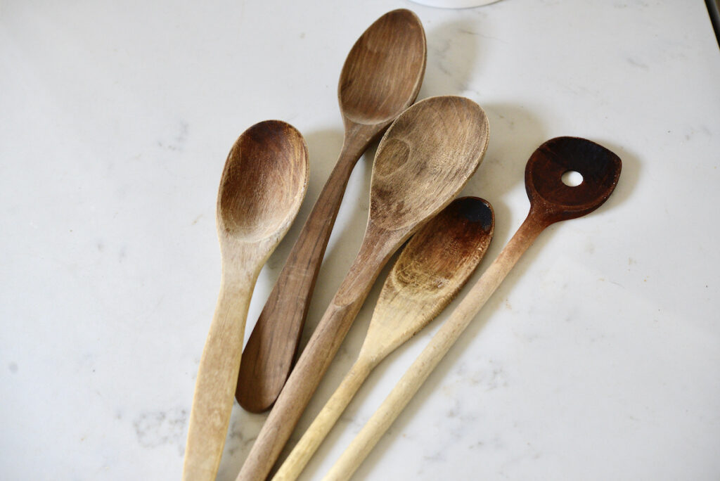 5 different wooden spoons on kitchen counter