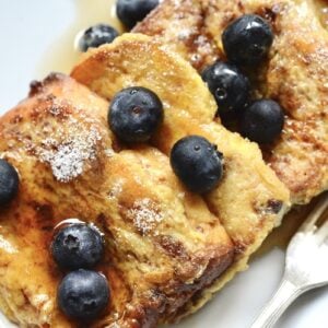 slices of anettone French toast on plate with blueberries