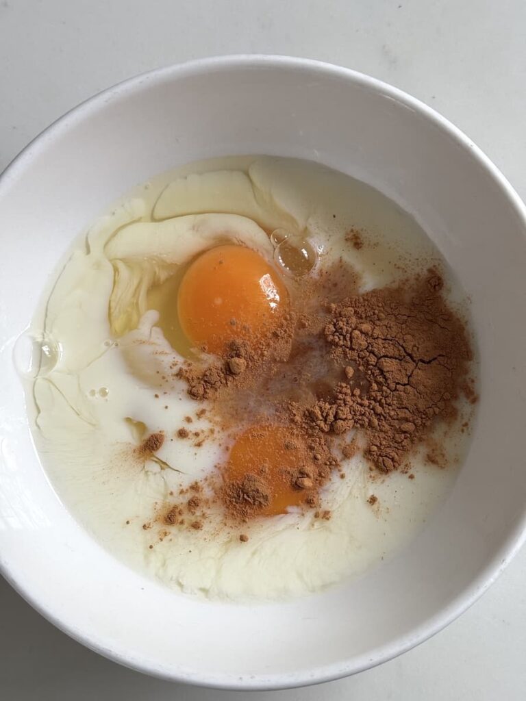 bowl with egg, milk, cinnamon powder, and vanilla extract