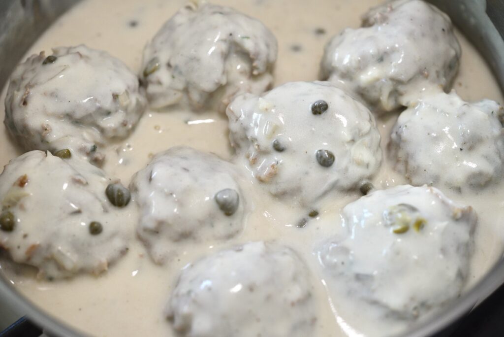 German meatballs in white sauce with capers