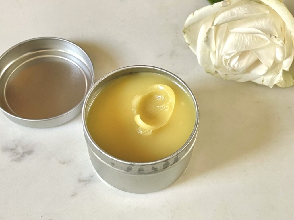 homemade hand cream in jar and a rose 