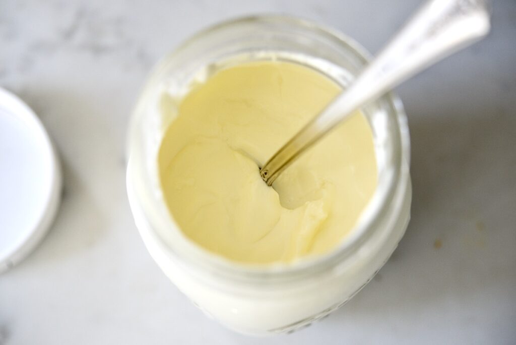 sour cream with spoon in mason jar
