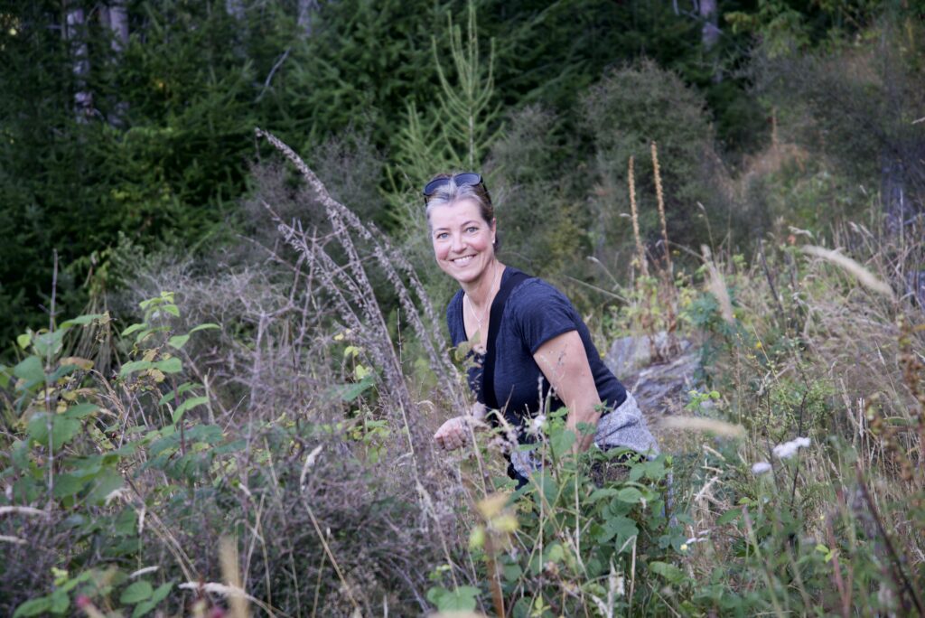 woman standing in a field of plants