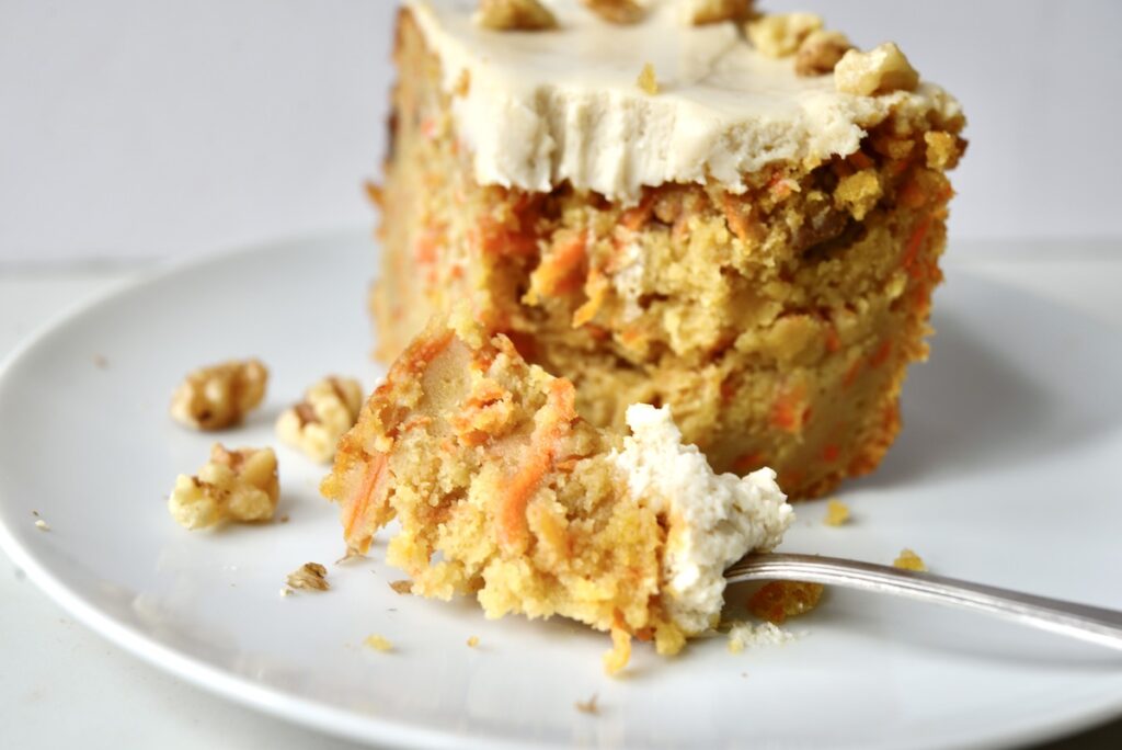 slice of sourdough carrot cake with maple cream cheese frosting. 