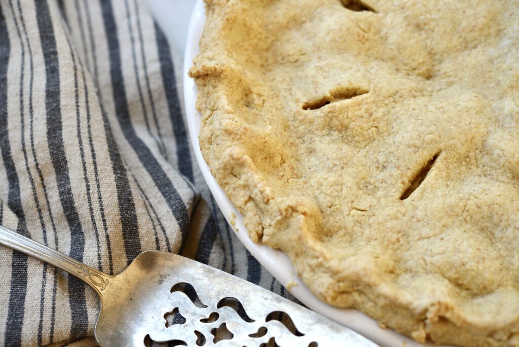 pie crust in baking dish with pie server