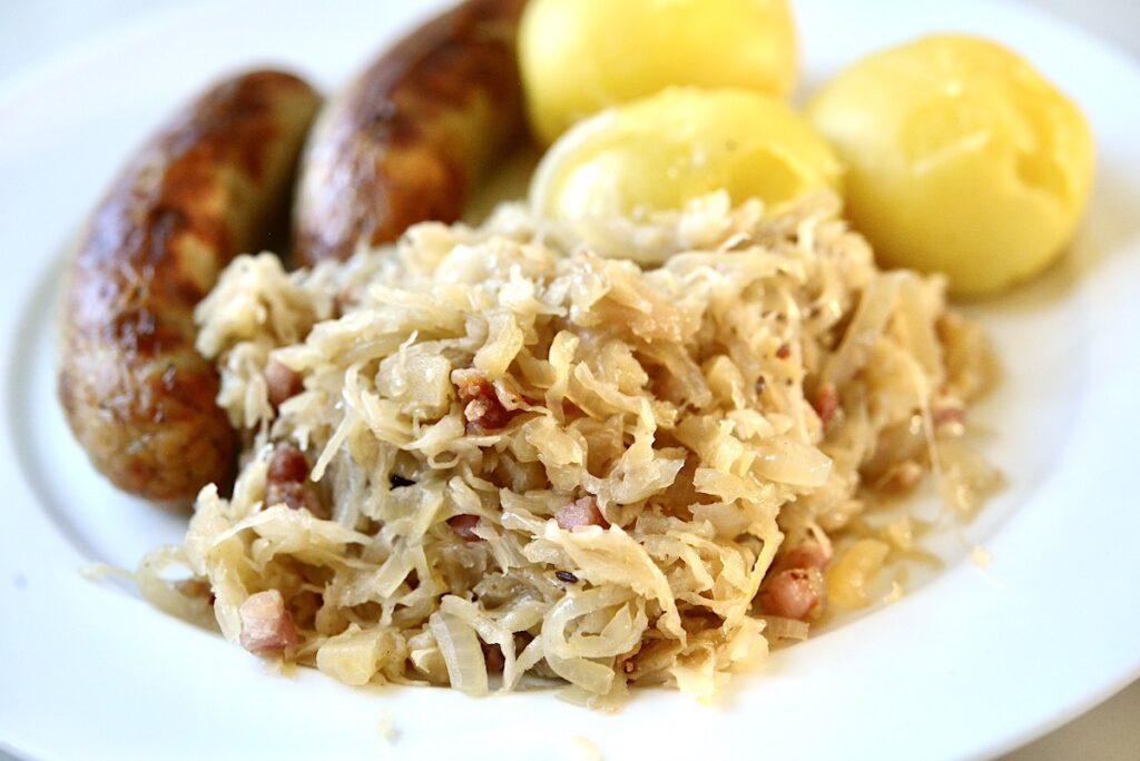 sauerkraut with bratwurst and potatoes on a plate