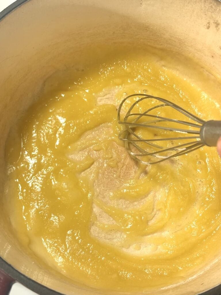 making a roux in a pot with wire whisk
