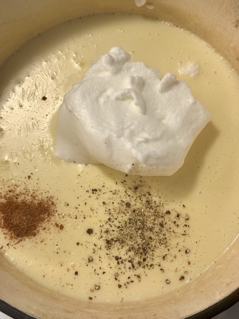 ham and noodle casserole sauce in pot with whipped egg whites and spices