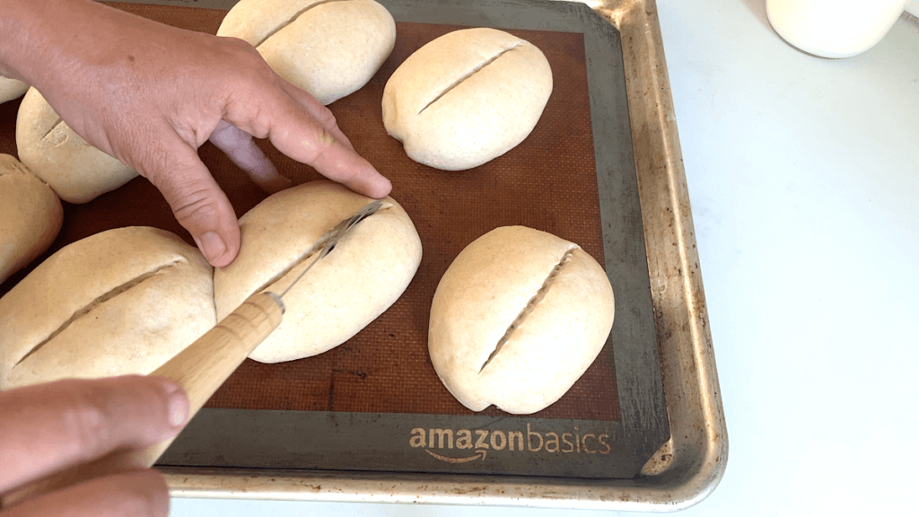 scoring German bread rolls with a lame