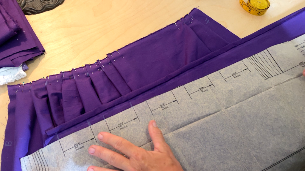 marking the pleats of the skirt