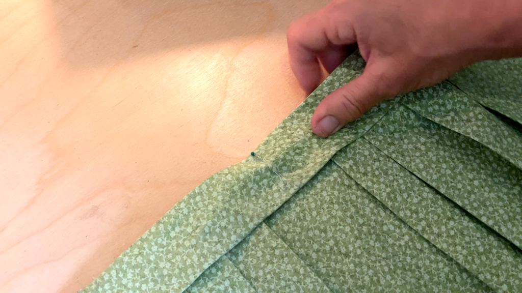 sewing the ribbon to the skirt