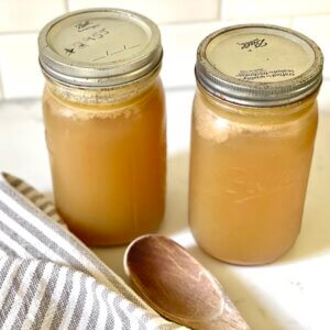 homemade bone broth in mason jars on kitchen counter