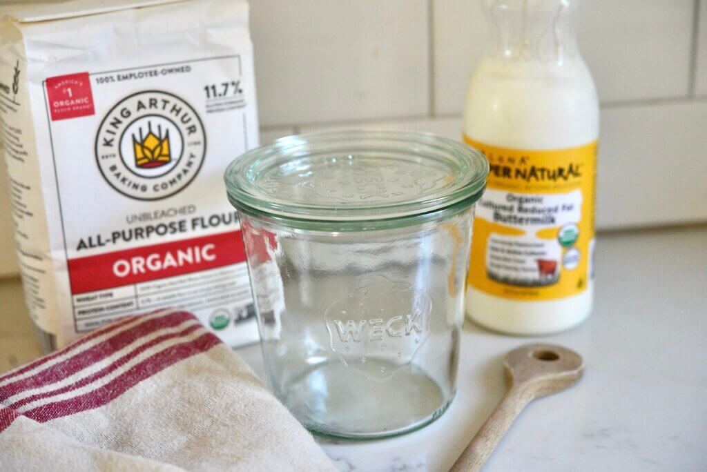 flour, buttermilk, glass jar for making your own sourdough starter