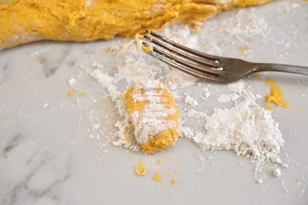 pumpkin gnocchi dough rolled out on work surface