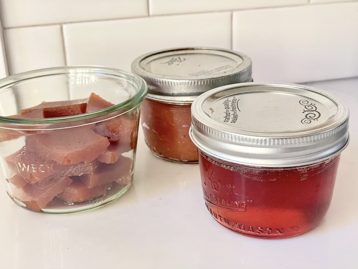 jars of quince jelly and quince paste on kitchen counter