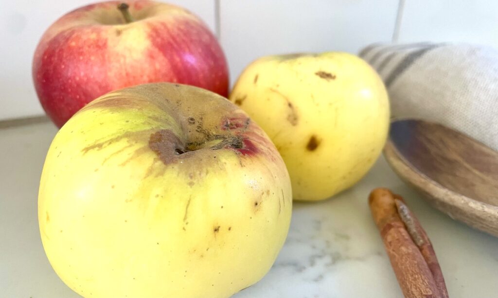 apples with cinnamon stick on kitchen counter