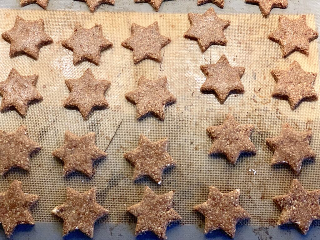 german cinnamon star cookies on silicone baking mat