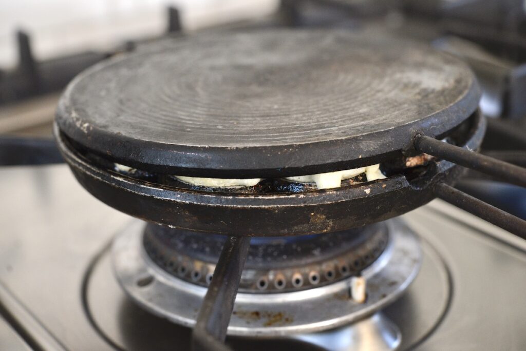 cast iron waffle maker on stove