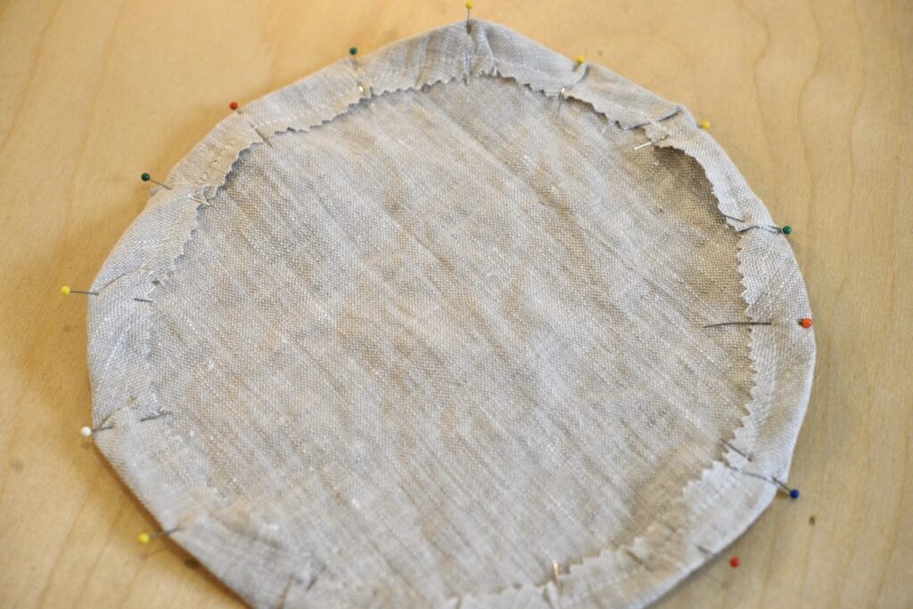 round piece of fabric with the hem pinned