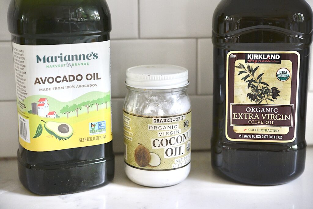 olive oil, avocado oil, and coconut oil on kitchen counter
