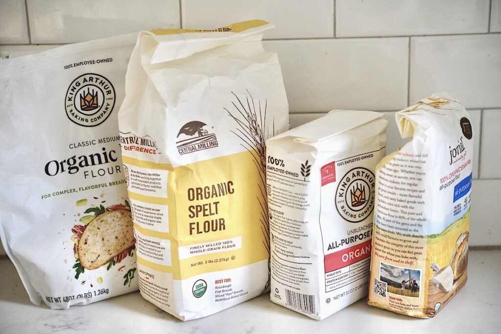different flours on kitchen counter to stock the pantry for the holidays