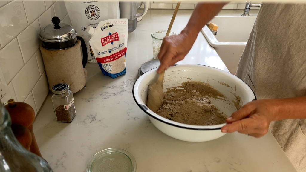 mixing the dough in large bowl on kitchen counter
