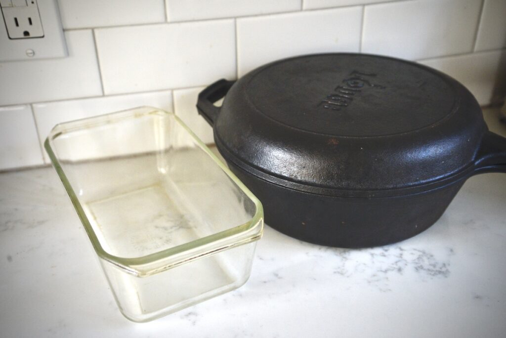 glass loaf pan and cast iron dutch oven on kitchen counter