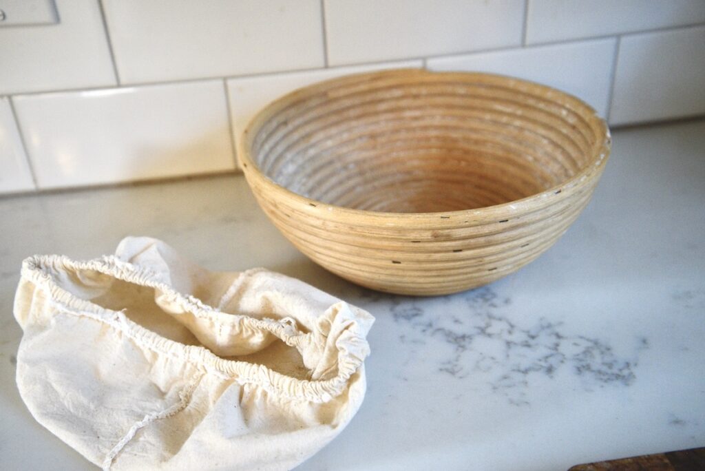 rattan bread proofing basket and liner on kitchen counter