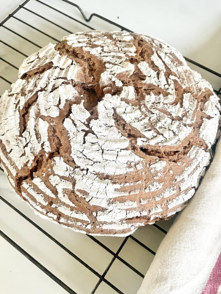 loaf of rye bread on wire rack
