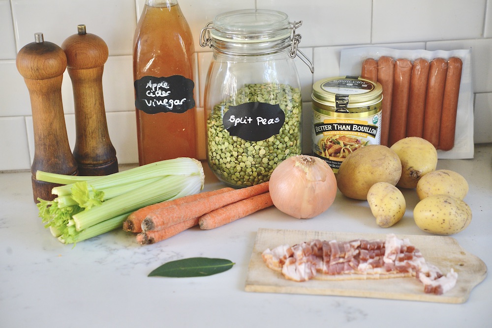 ingredients for split pea soup: celery, carrots, potatoes, bacon, onion, split peas, bouillon, sausages, bay leaf, vinegar, salt, pepper