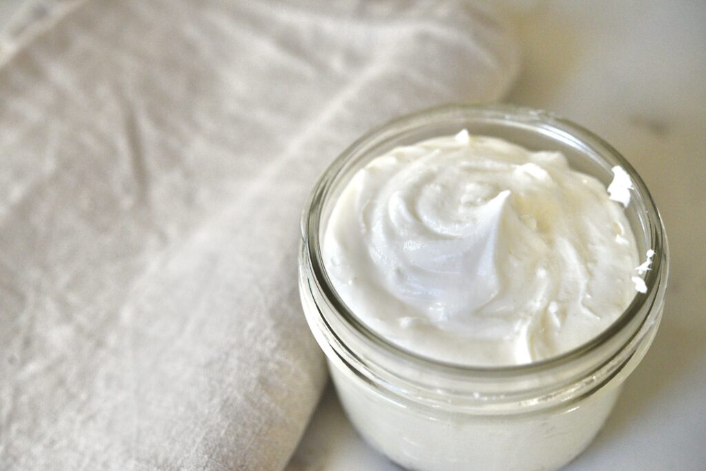 whipped tallow balm in glass jar with linen towel