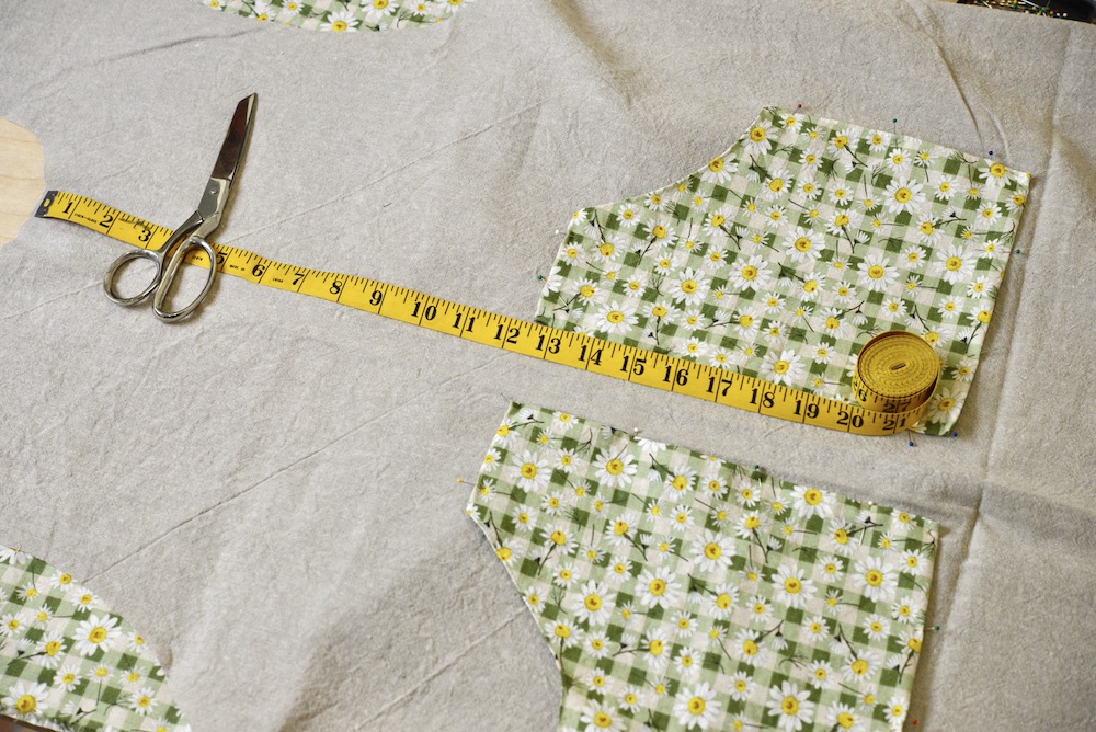 pockets placed on apron with measuring tape and scissors