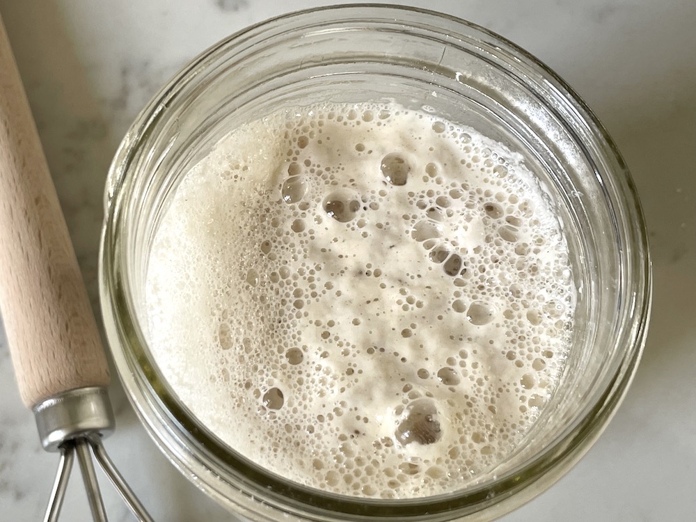 active sourdough starter in glass jar 