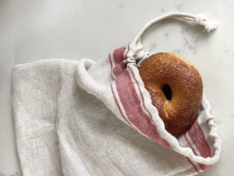 linen bread bag with bagel sticking out