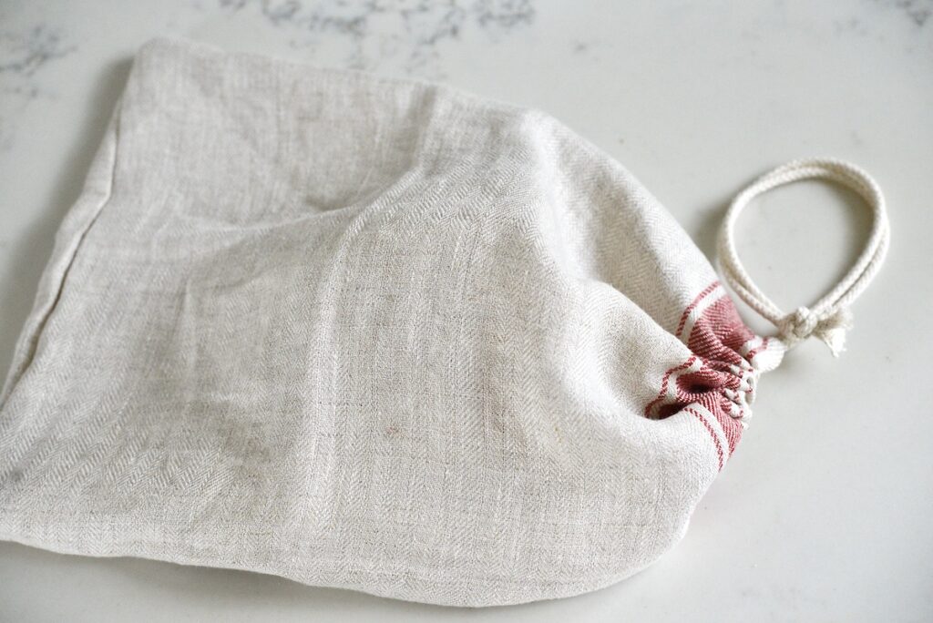 linen bread bag with drawstring on kitchen counter