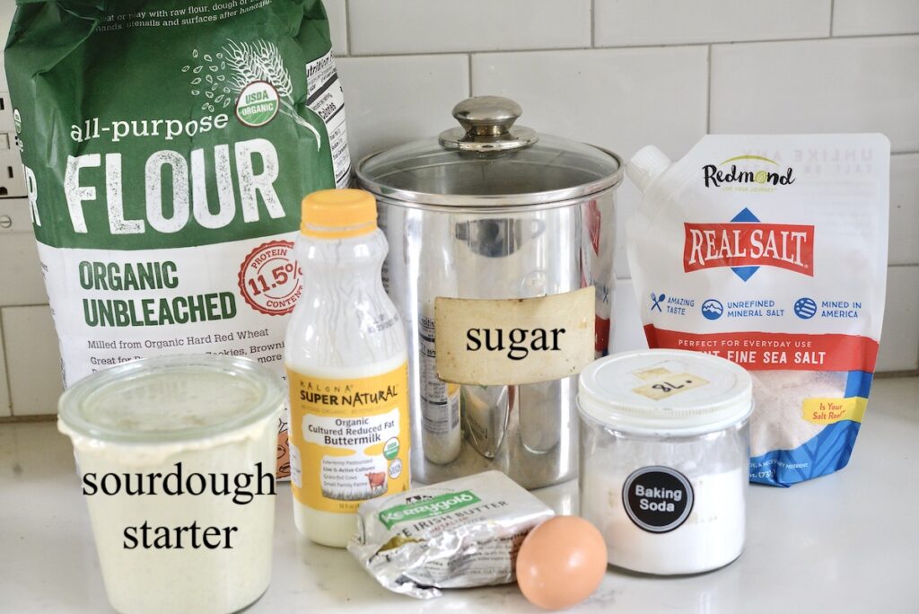 flour, sugar, salt, sourdough starter, buttermilk, butter, egg, baking soda on kitchen counter
