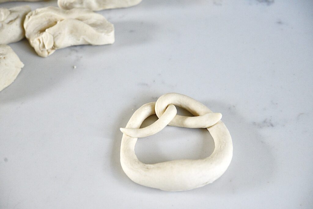 unbaked shaped pretzel on kitchen counter