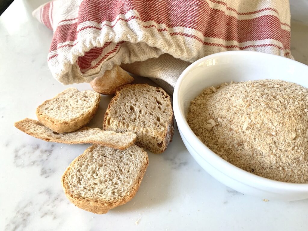 linen bread bag with pieces of dried bread and bread crumbs