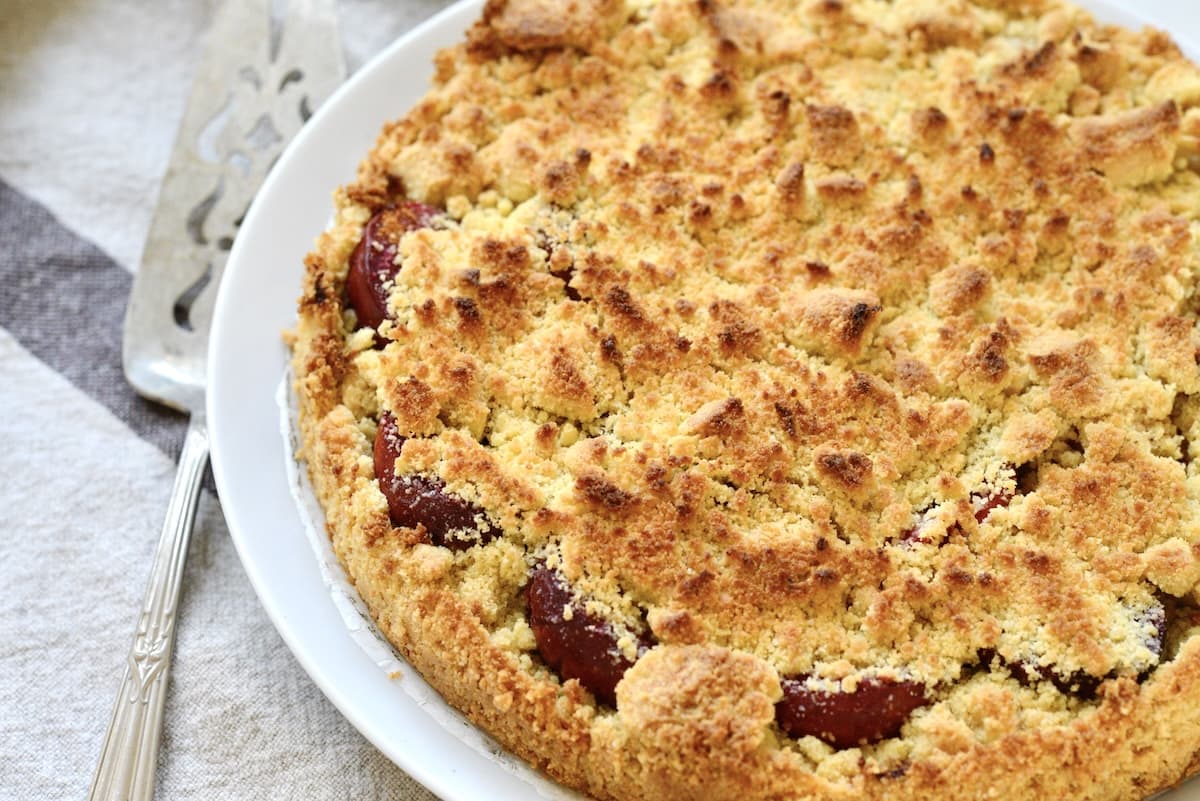 crumb cake with plums on plate