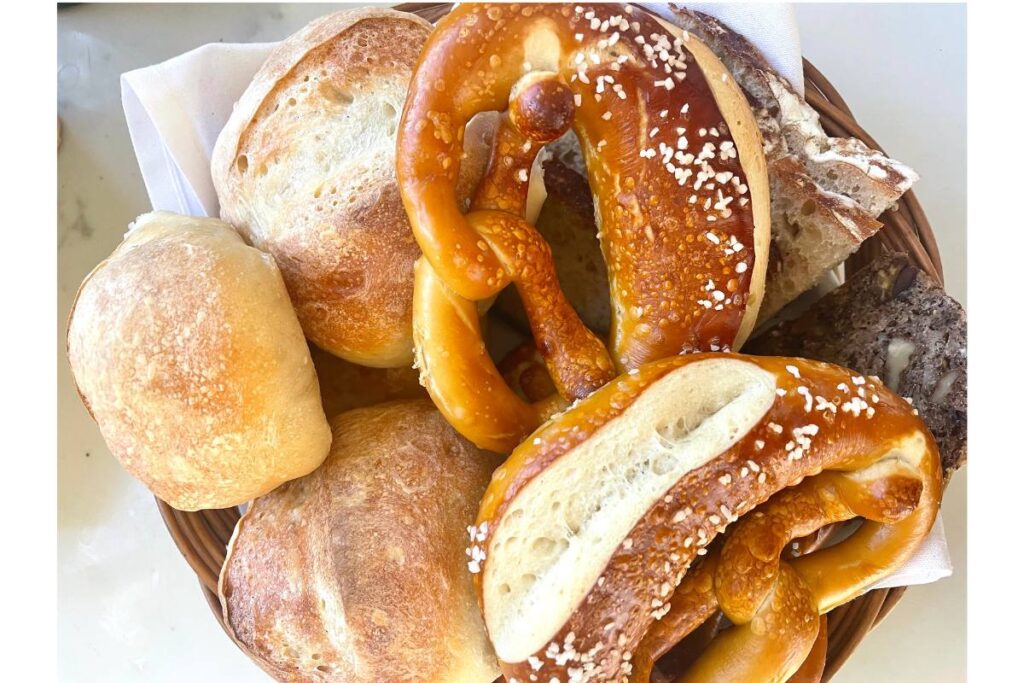 bread basket with pretzels, rolls, and dark bread