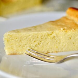 slice of German cheesecake on plate with fork