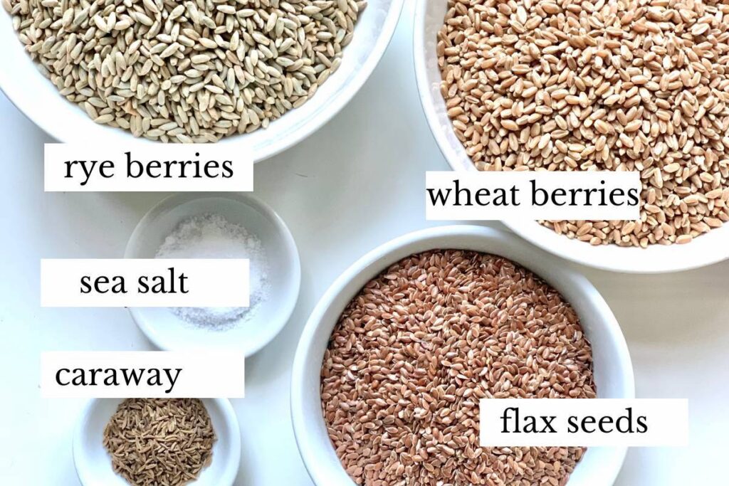 ingredients for whole grain sourdough bread: rye berries, wheat berries, sea salt, caraway, flax seeds