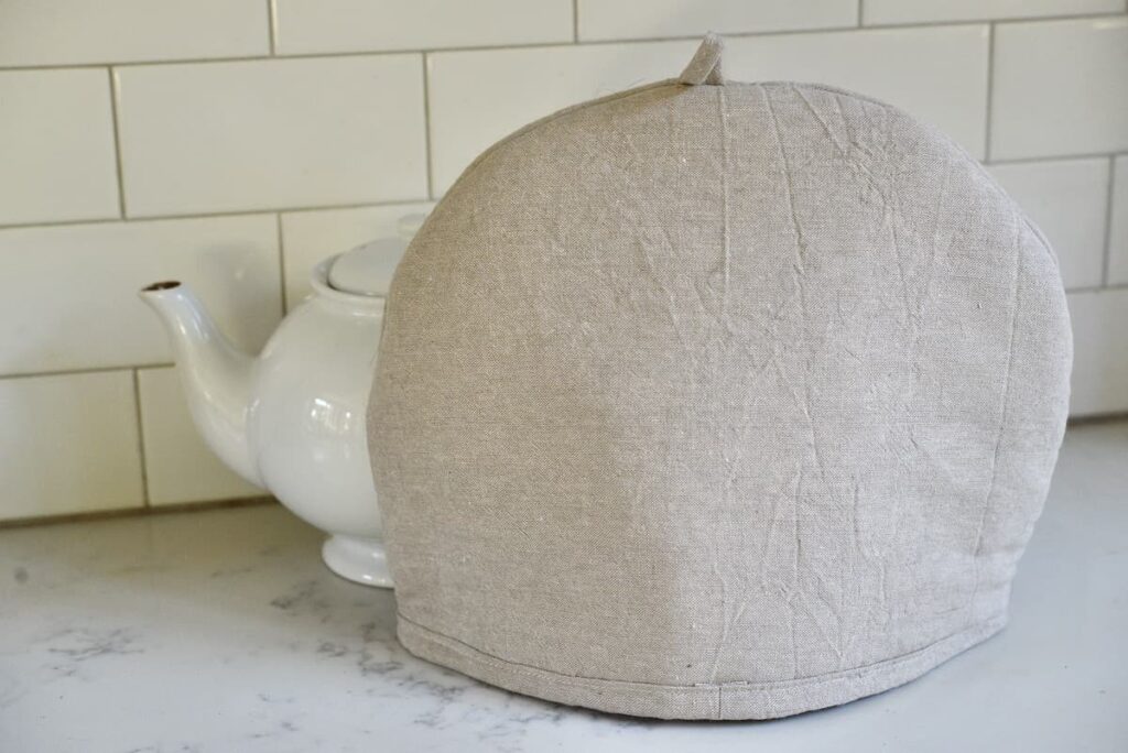 tea cozy in front of white tea pot