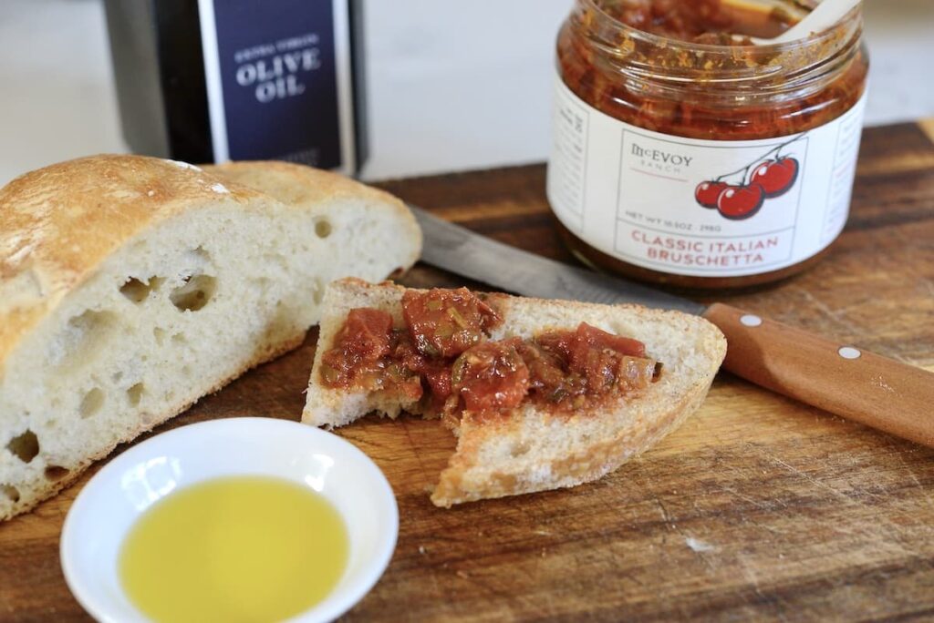 slices of sourdough bread with Italian bruschetta on cutting board