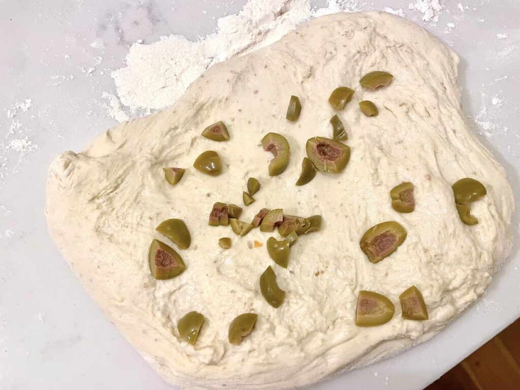 sourdough bread dough with chopped green olives