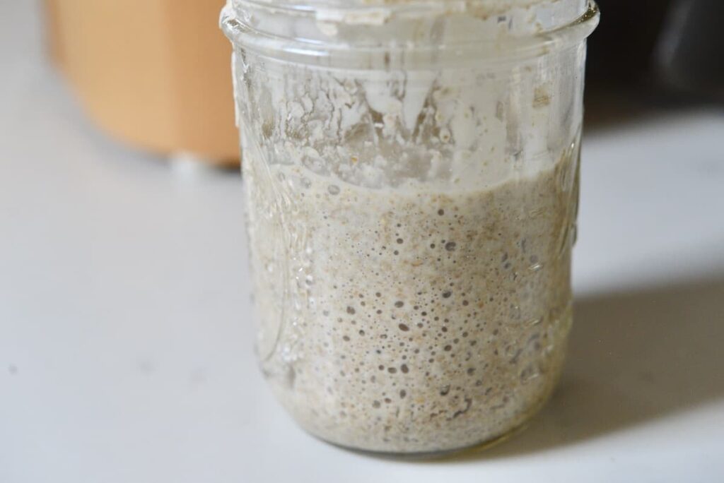 sourdough starter in jar with lots of bubbles
