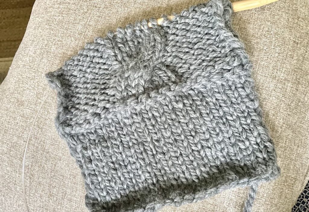 knitted swatch with stockinette stich and cable stitch